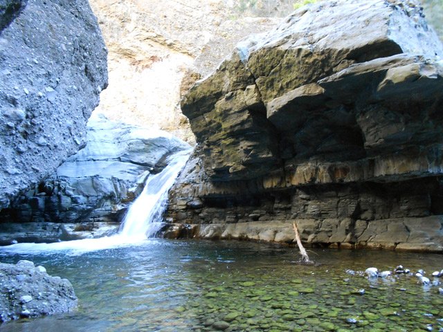 Bassin d'eau transparente alimenté par un petit toboggan