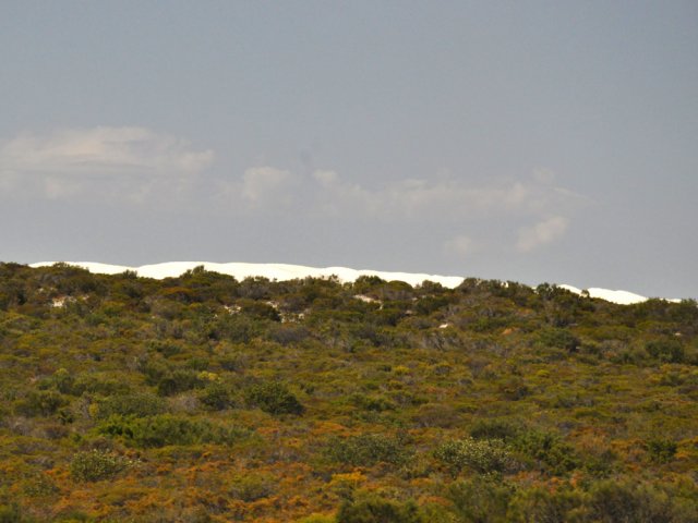 Depuis les vitres du véhicule, on devine les premières dunes blanches